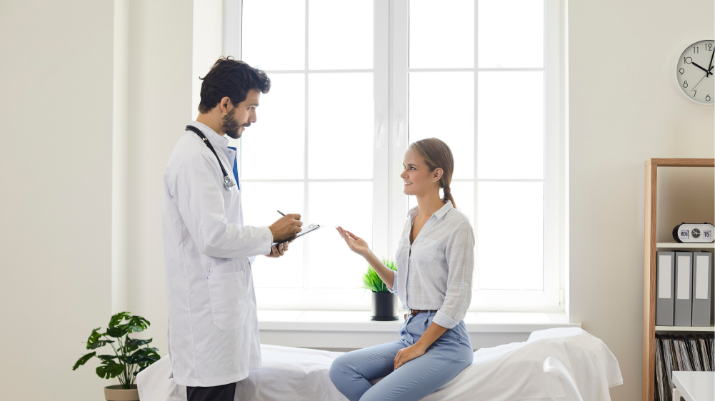 A male doctor discussing with a female patient.