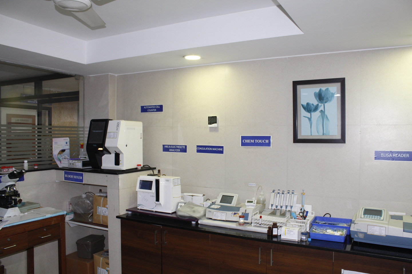 A view of the lab infrastructure at Sri Balaji Hospital showing blood mixture, automated cell counter, and other equipment.